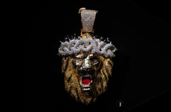 Gold lion pendant with diamo<em></em>nds and a crown, owned by Big Sean, on display at the Ice Cold: An Exhibition of Hip-Hop Jewelry