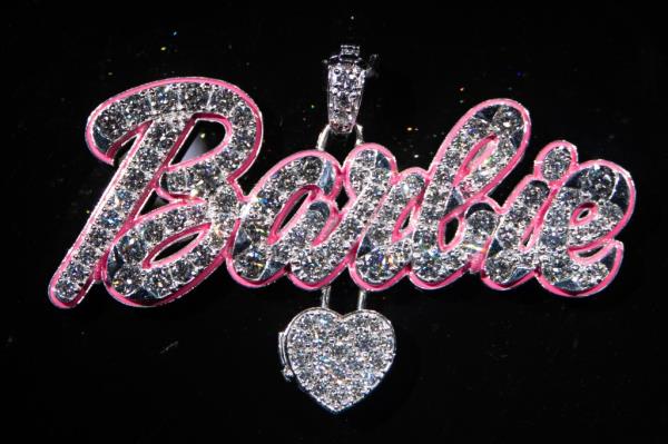 Ashna Mehta's 18k gold Barbie pendant for Nicki Minaj, adorned with 54.47 carats of diamo<em></em>nds and pink enamel outline, displayed at the Hip-Hop Jewelry exhibition.