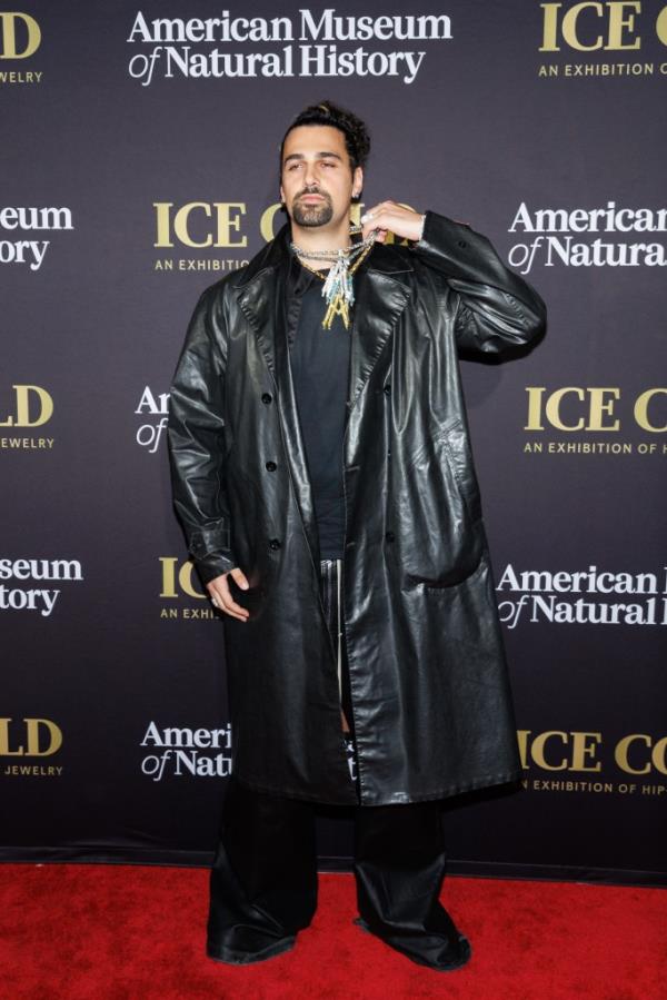 Alex Moss, a New York City-ba<em></em>sed jeweler in a long black coat, known for his 3D diamond pendants, bubble-letter diamond chains, and mini sculpture rings