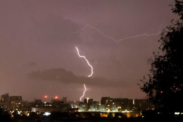 ?George Cracknell Wright 18/09/2023 London, United Kingdom Lo<em></em>ndon Lightning Strike A lightning strike over buildings during a thunderstorm in Greenwich South East London. A yellow and amber weather warning for thunderstorms is in place in part of the United Kingdom. Photo Credit: George Cracknell Wright