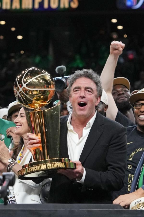 Wyc Grousbeck holds the champio<em></em>nsip trophy after the Celtics win the title.