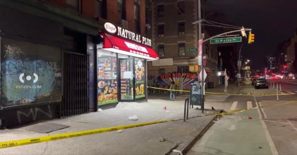 A yellow police tape surrounds a storefront with a sign.