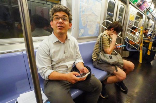 Lincoln Restler, councilmember for District 33, riding the G train on Thursday.  