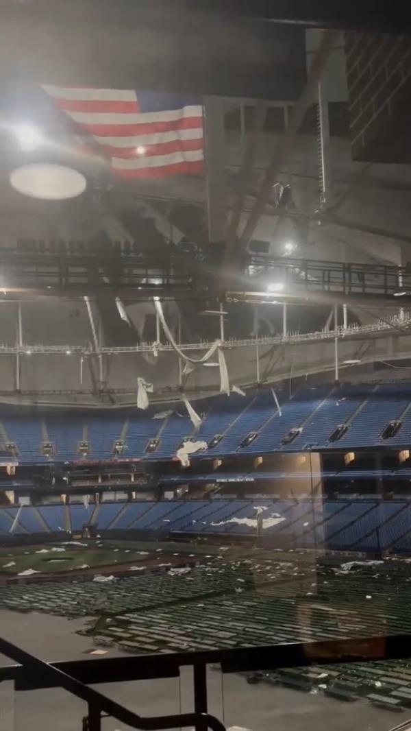 Large sheets of the white roof fabric hung from the stadium's catwalks.