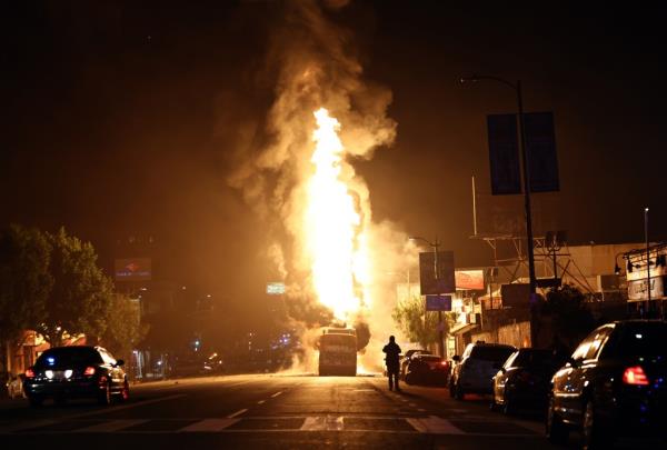 A Metro bus bus burns following Dodger fan celebrations in the area in Echo Park