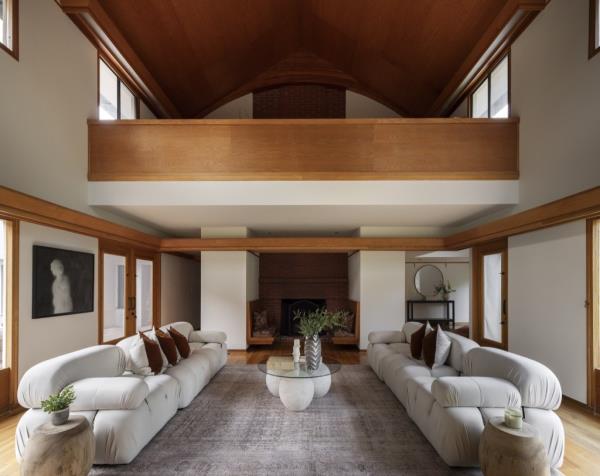 The modern home features lots of wood paneling and a mezzanine level.