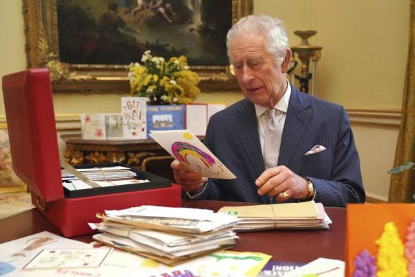 Britain's King Charles III reads cards and messages, sent by wellwishers following his cancer diagnosis, in the 18th Century Room of the Belgian Suite in Buckingham Palace, London, on Feb. 21.