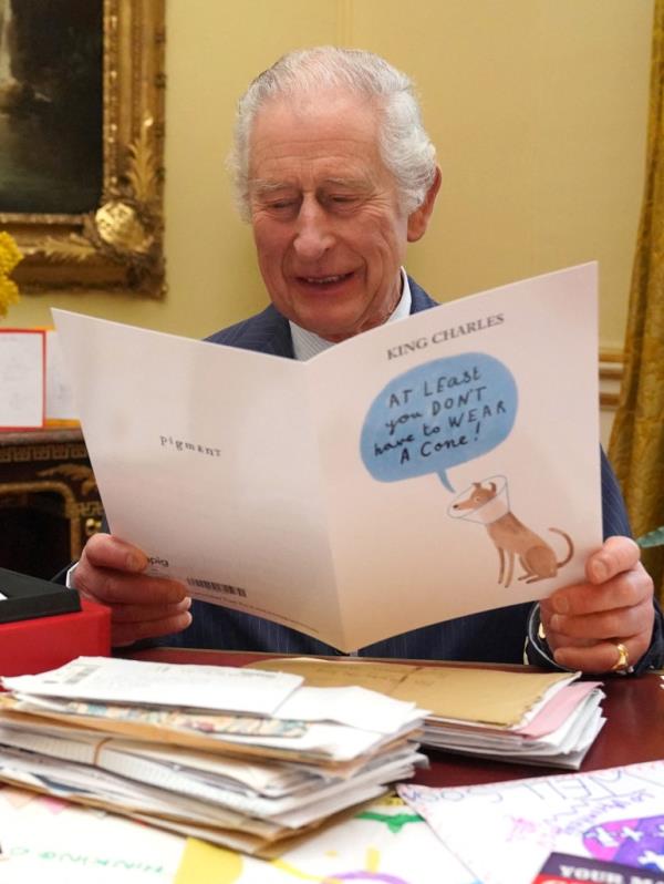 Britain's King Charles III reads cards and messages, sent by wellwishers following his cancer diagnosis, in the 18th Century Room of the Belgian Suite in Buckingham Palace, London, on Feb. 21.