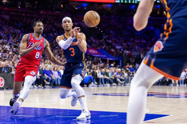 Josh Hart #3 of the New York Knicks passes the ball as DeaAnthony Melton #8 of the Philadelphia 76ers rushes to defend