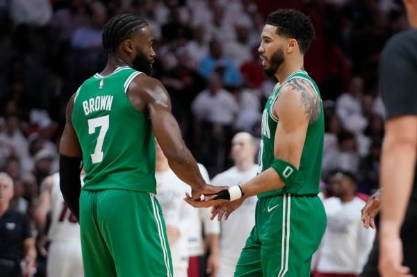 Boston Celtics forward Jayson Tatum (0) and guard Jaylen Brown (7) co<em></em>ngratulate each other during the second half of Game 4 during the NBA basketball playoffs Eastern Co<em></em>nference finals against the Miami Heat, Tuesday, May 23, 2023, in Miami.