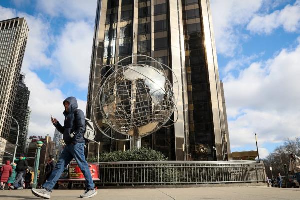 A man walks past the Columbus Circle globe outside the Trump Internatio<em></em>nal Hotel in Manhattan, New York City, U.S., March 19, 2024. 