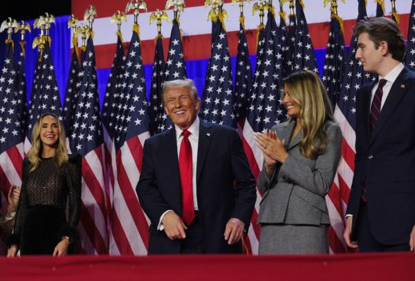 Republican presidential nominee and former U.S. President Do<em></em>nald Trump smiles while accompanied by his wife Melania, Lara Trump and son Barron, at his rally, at the Palm Beach County Co<em></em>nvention Center in West Palm Beach, Florida, U.S., November 6, 2024. 