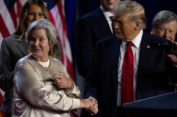 Republican presidential nominee and former U.S. President Do<em></em>nald Trump shakes hands with his senior advisor Susie Wiles as he speaks, following early results from the 2024 U.S. presidential election in Palm Beach County Co<em></em>nvention Center, in West Palm Beach, Florida, U.S., November 6, 2024.