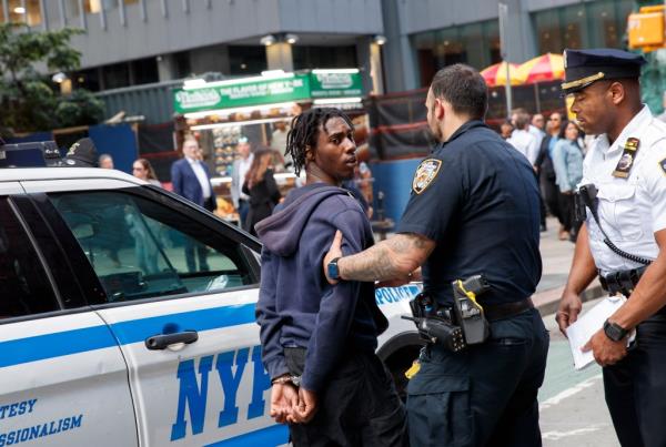 A photo of police escorting a man they arrested in a May in Times Square for an alleged machete attack.