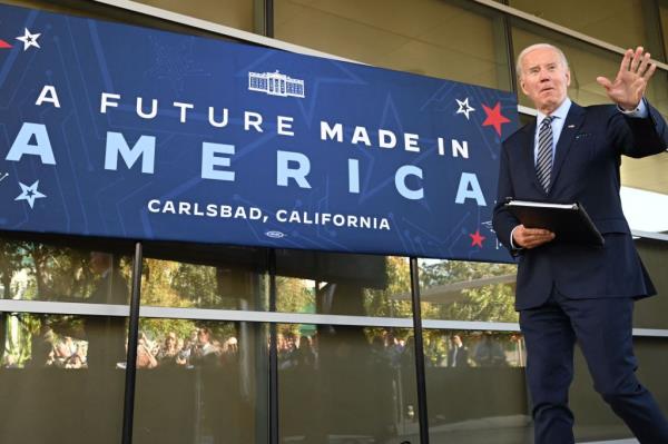 US President Joe Biden standing in front of a banner at ViaSat, preparing to speak a<em></em>bout the CHIPS and Science Act, in Carlsbad, California, on November 4, 2022