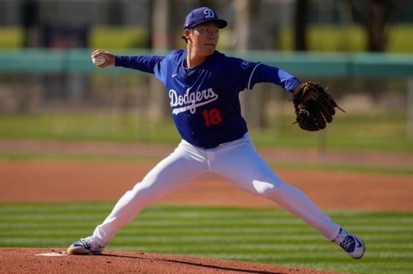 Yoshinobu Yamamoto of Los Angeles Dodgers throwing a pitch during spring training at Camelback Ranch in Phoenix.