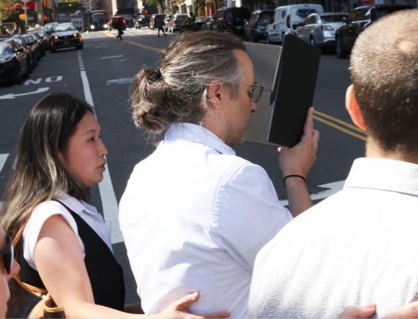Zachariah Reed tried to duck a photographer as he leaves court on Thursday, with his lawyer, Nicky Rooz.