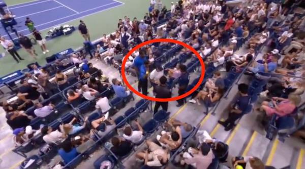 U.S. Open security remove an unruly fan from the stands.