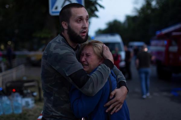 People react outside the restaurant on Tuesday night.