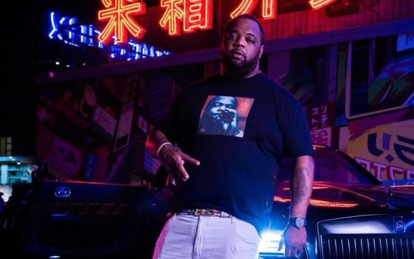 Big Pokey leaning on a car in a promotio<em></em>nal photo