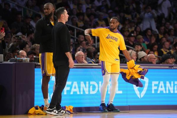 LeBron James and Bro<em></em>nny James checking into a Lakers basketball game, as observed by head coach JJ Redick