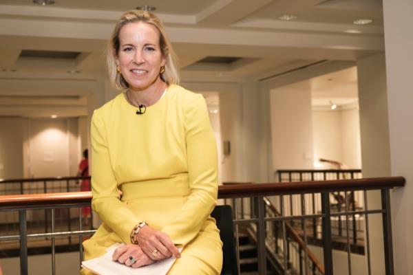 Bo<em></em>nnie Brennan, President of Americas at Christie's auction house, wearing a yellow dress at 20 Rockefeller Plaza, Manhattan NY