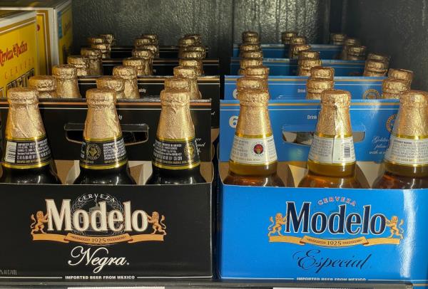 Bottles of Modelo beer displayed on a store shelf.