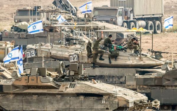 Israeli soldiers gathered for the scenario of ground maneuvers at an undisclosed location near the border with Gaza.