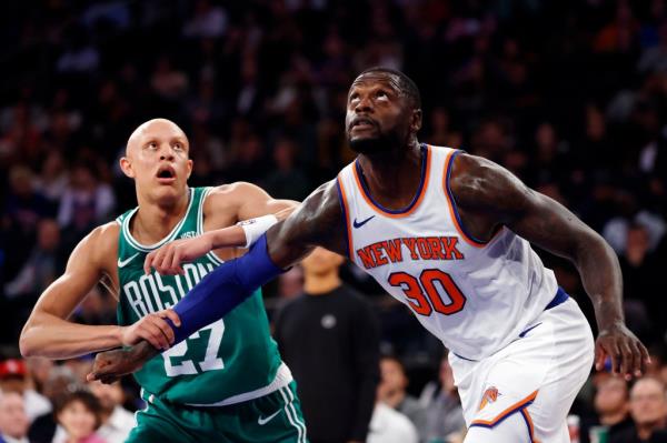 Julius Randle, battling Jordan Walsh for a rebound, played 13 minutes in the Knicks' 114-107 preseason win over the Celtics.