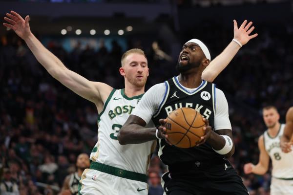Bobby Portis #9 of the Milwaukee Bucks drives to the basket against Sam Hauser #30 of the Boston Celtics during the first half of a game at Fiserv Forum on January 11, 2024.