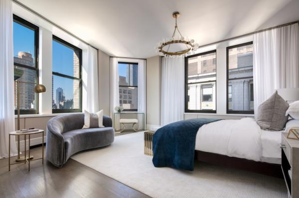 A main bedroom with a sitting area -- and city views.