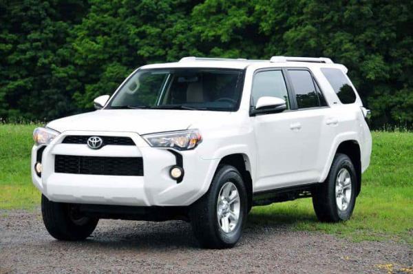 Lang and her vehicle, a 2016 White 4 Runner SUV with a customized Colorado license plate reading 