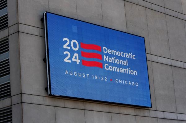 An LED sign located on the United Center displays a DNC 2024 logo and information.