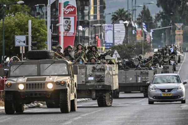 Israeli soldiers patrol in armoured perso<em></em>nnel carriers at an undisclosed position in northern Israel near the border with Lebanon on October 15, 2023. 