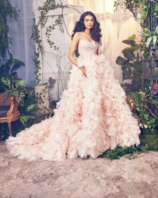 “Pink symbolizes romance and warmth,” said designer Ines Di Santo. “While white remains a timeless tradition, I appreciate the allure of something different.”