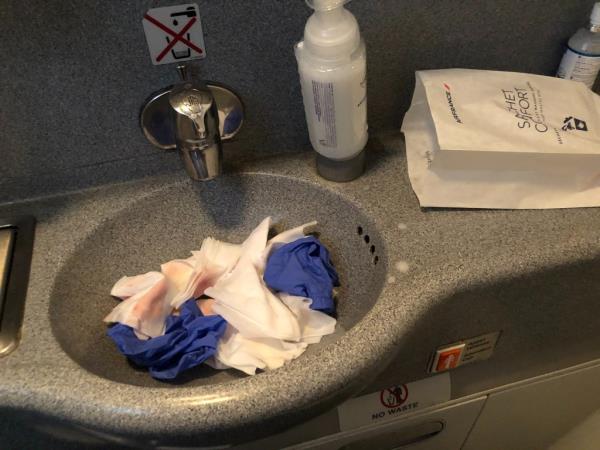 Bloody napkins and gloves in plane sink