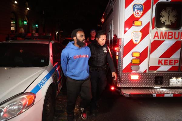 Laron Modlin is escorted to an ambulance.