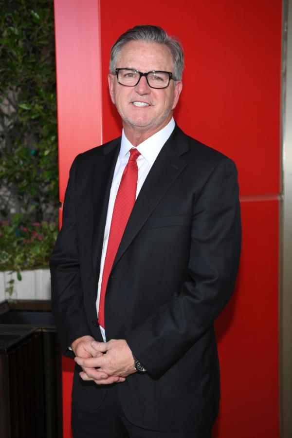 Scott Sibella standing and smiling