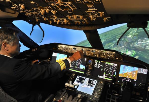 An All Nippon Airways captain operates the latest flight simulator for the Boeing's 787 Deamliner at ANA's training center.