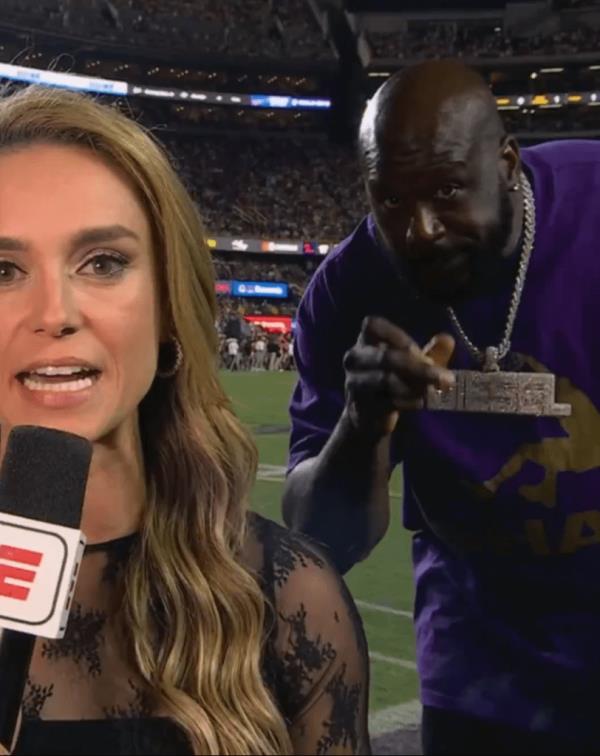 Shaq photobombs Molly McGrath while she was reporting on the LSU-Ole Miss game on Saturday night.