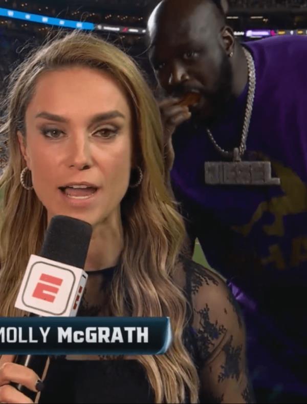 Shaq photobombs Molly McGrath while she was reporting on the LSU-Ole Miss game on Saturday night.