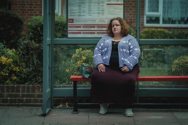 Martha (Jessica Gunning) sitting on a bench. 
