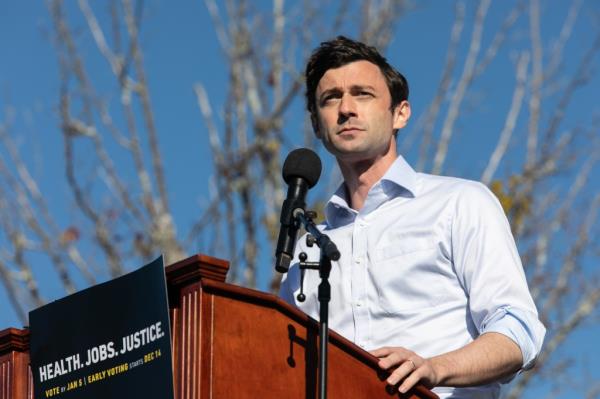 Democratic U.S. Senate candidate Jon Ossoff speaking to a crowd at an outdoor drive-in rally in Conyers, Georgia on December 5, 2020