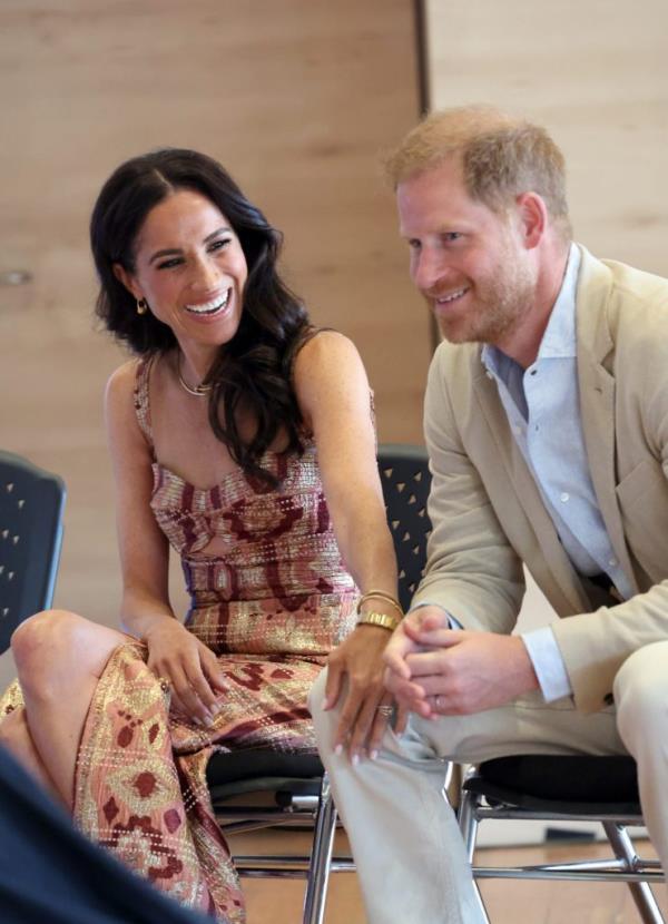 Prince Harry and Meghan, Duchess of Sussex, sitting in chairs during their visit to Centro Nacio<em></em>nal de las Artes Delia Zapata in Bogota, Colombia