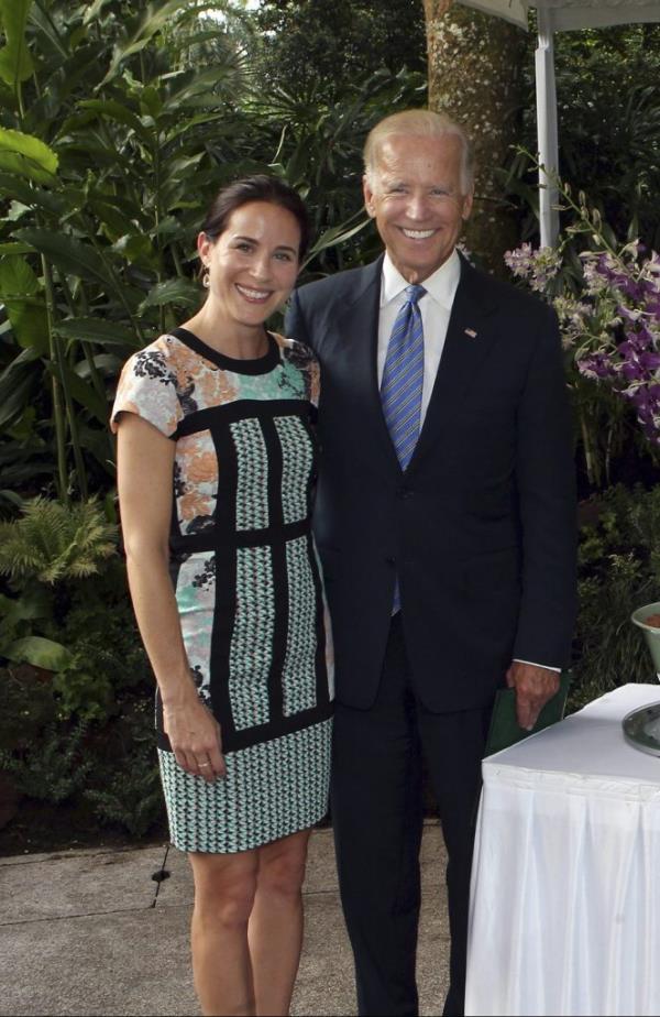 U.S. Vice President Joe Biden, his wife Jill, daughter Ashley, and son-in-law Howard Krein smiling next to a newly named orchid hybrid at the Natio<em></em>nal Orchid Garden in Singapore.