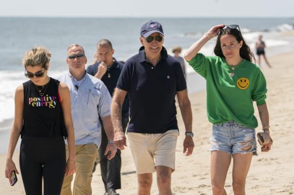 President Joe Biden walking on the beach with his granddaughter Natalie Biden and daughter Ashley Biden