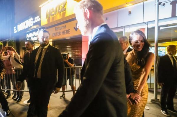 Megan Markle and Prince Harry attend Ms. Foundation's Woman of Vision Gala. Megan wears a gold dress while receiving an award from Gloria Steinem.