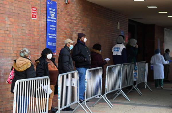People wearing face masks outside of a COVID-19 testing site in New York City