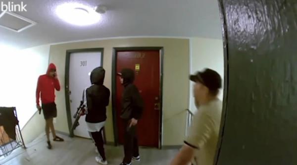Group of armed men flaunting guns in a hallway of a Colorado apartment building