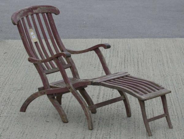 A mahogany deck chair, with a tiny White Star Line emblem carved into the headrest